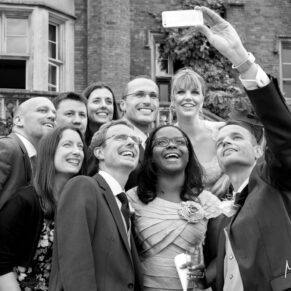 It's selfie time for the newlyweds with their friends during their drinks reception in the gardens of the Latimer Estate