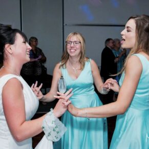 Fun antics on the dance floor for the bride and her bridesmaids during the evening reception