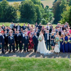 Photography of everyone captured from up high at the Latimer Estate for this summer wedding celebration with distant views of the Chess Valley in the distance