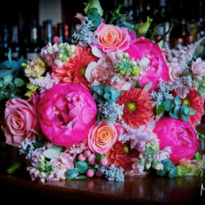 Vibrant summer bouquet captured with gorgeous window lighting at the Latimer Estate