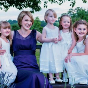 Proud mum poses with her flower girl daughters at this Latimer Estate summer wedding