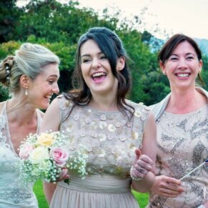 The bride and her bridesmaids captured larking around during the drinks reception