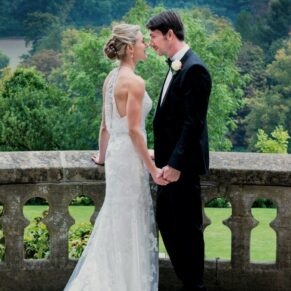 Romantic pose of the newlyweds on the hotel terrace at their Latimer Estate summer wedding