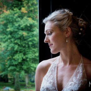 Dramatic pose of the bride in the entrance doorway on the Latimer Estate