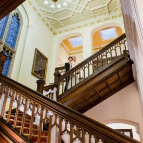 The newlyweds on the fabulous staircase inside the main house on the Latimer Estate