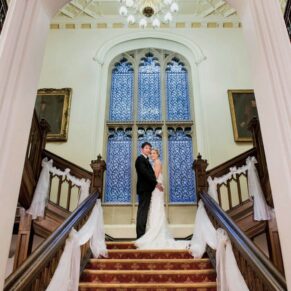 The newlyweds strike a pose on the grand staircase in the main house