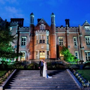 Dramatic dusk pose of the bride and groom outside the hotel on the grand steps at their Latimer Estate wedding