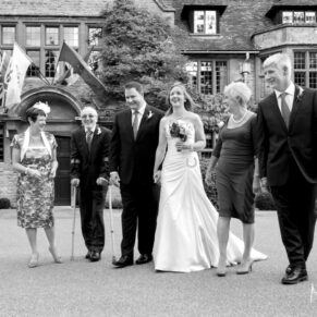The bridal party take a stroll in front of the hotel at this Le Manoir Aux Quat Saisons wedding in Oxfordshire