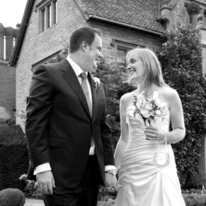 The newlyweds outside the hotel in a casual pose at Le Manoir Aux Quat Saisons