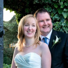 The newlyweds pose for the camera in a close-up pose in the gardens of their Le Manoir Aux Quat Saisons wedding