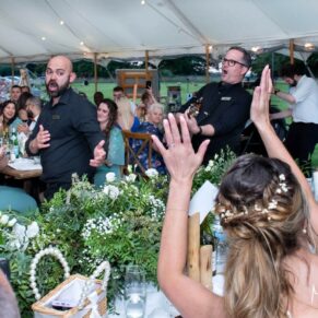 The energetic singing waiters had the enthusiastic bride joining in during the lively evening reception at her marriage celebrations in Old Windsor
