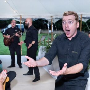 The energetic singing waiters entertain the crowd during the evening reception
