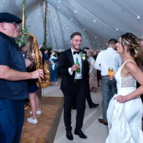 The bride and groom enjoying the dancing during their lively evening reception in the marquee
