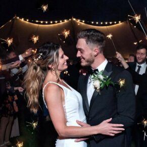 The newlyweds enjoying their sparkler aisle at the end of the evening at their Windsor summer celebrations
