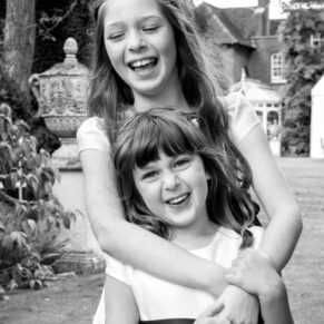 Micklefield Hall Wedding Photography - two sisters enjoying a hug in the gardens