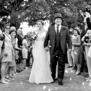 Micklefield Hall Wedding Photography - confetti aisle capture withy the newlyweds loving every moment