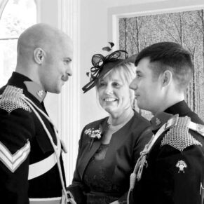 The groom chats to his mum and best man in the Garden Room at the abbey