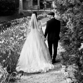 The newlyweds take a stroll through the gardens towards the summerhouse at their Buckinghamshire venue