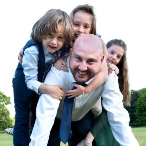 One of the guest's larking around with some of the children in the gardens during the wedding drinks reception