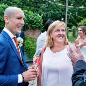 Monkton Barn Wedding Photography - guests chatting to the groom in the courtyard