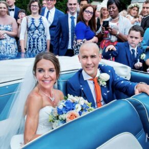 Monkton Barn Wedding Photography - the guests gather around the newlyweds car to congratulate the bride and groom