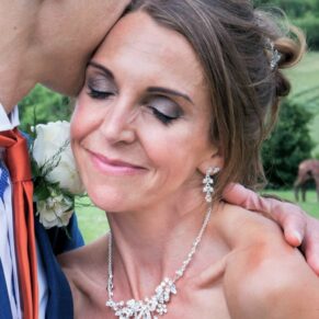 Monkton Barn Wedding Photography - a loving kiss for the bride from her husband