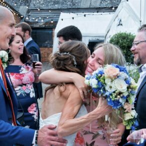 Monkton Barn Wedding Photography - a big hug for the bride during the drinks reception