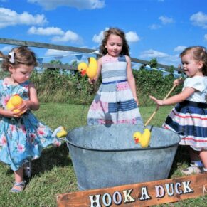 Notley Tythe Barn Wedding Photography - vintage fairground games being enjoyed by these young guests