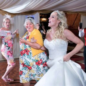 Notley Tythe Barn Wedding Photography - the bride enjoys a dance with one of her relatives
