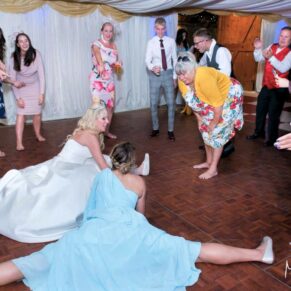 Notley Tythe Barn Wedding Photography - crazy dance moves from the bride and her bridesmaid
