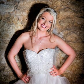 Notley Tythe Barn Wedding Photography - the bride poses for my camera against a stone wall