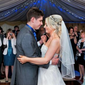 Notley Tythe Barn Wedding Photography - the newlyweds first dance inside the marquee