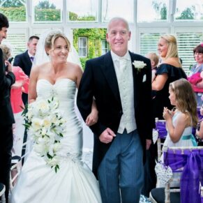 Odney Club Wedding Photography - the newlyweds exit their conservatory civil ceremony