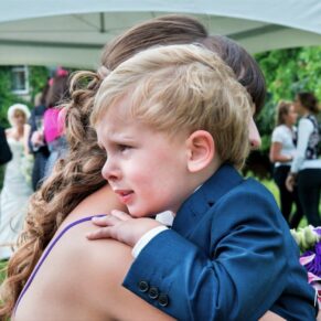Odney Club Wedding Photography - tears captured of this young lad whilst hugging mum