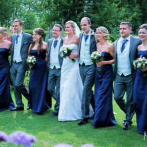 Odney Club Wedding Photography - natural walking shot of the bridal party in the gorgeous gardens