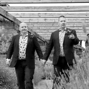 Same Sex Buckinghamshire Wedding Photography - the grooms walk through a flower arbour