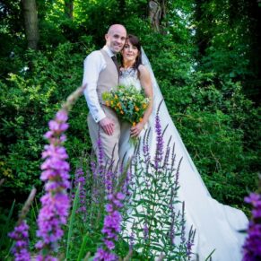 The smiling newlyweds captured in the stunning surroundings of the Secret Garden at The Dairy