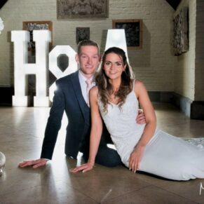 The newlyweds captured in front of their giant illuminated letters during the evening reception