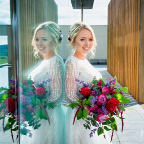 Dramatic bridal portrait captured at Windmill Hill on the Waddesdon Estate with distant views and reflections used to great effect