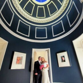 A dramatic classic pose of the newlyweds inside this this high ceilinged part of the historic Grove Hotel