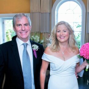 The bride and groom exit their indoor civil ceremony at The Grove Hotel in Watford
