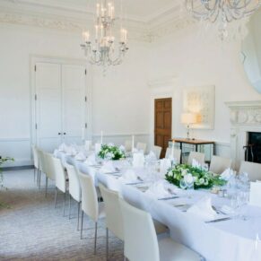 Stylish white room interior all set for the meal at The Grove Hotel in Hertfordshire