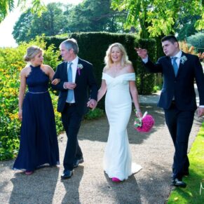 The couple and their children taking a stroll through the glorious gardens of The Grove Hotel