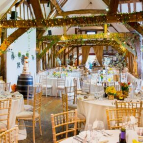 Old Luxters Wedding Photography - magical barn interiors showcasing the setup for the meal