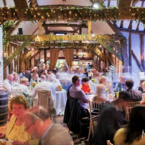 Old Luxters Wedding Photography - view from up high of all the guests inside the barn