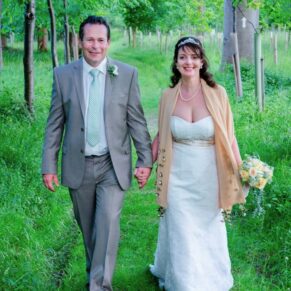 Old Luxters Wedding Photography - the newlyweds go for a stroll through a wooded area