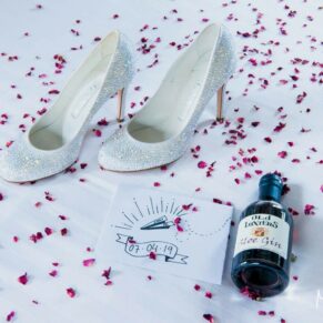 Old Luxters Wedding Photography - the bride's shoes and a gift bottle of gin from the venue