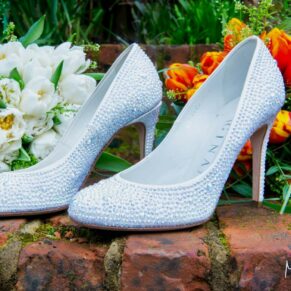 Old Luxters Wedding Photography - the bride's shoes surrounded by colourful flowers