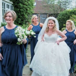 Old Luxters Wedding Photography - the bride in high spirits arriving at the ceremony