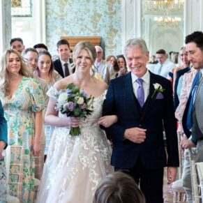The bride with her father entering the indoor civil wedding ceremony at Pendley Manor Hotel